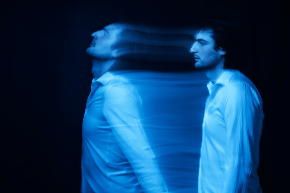 blurred silhouette of ghost man's soul on a dark background